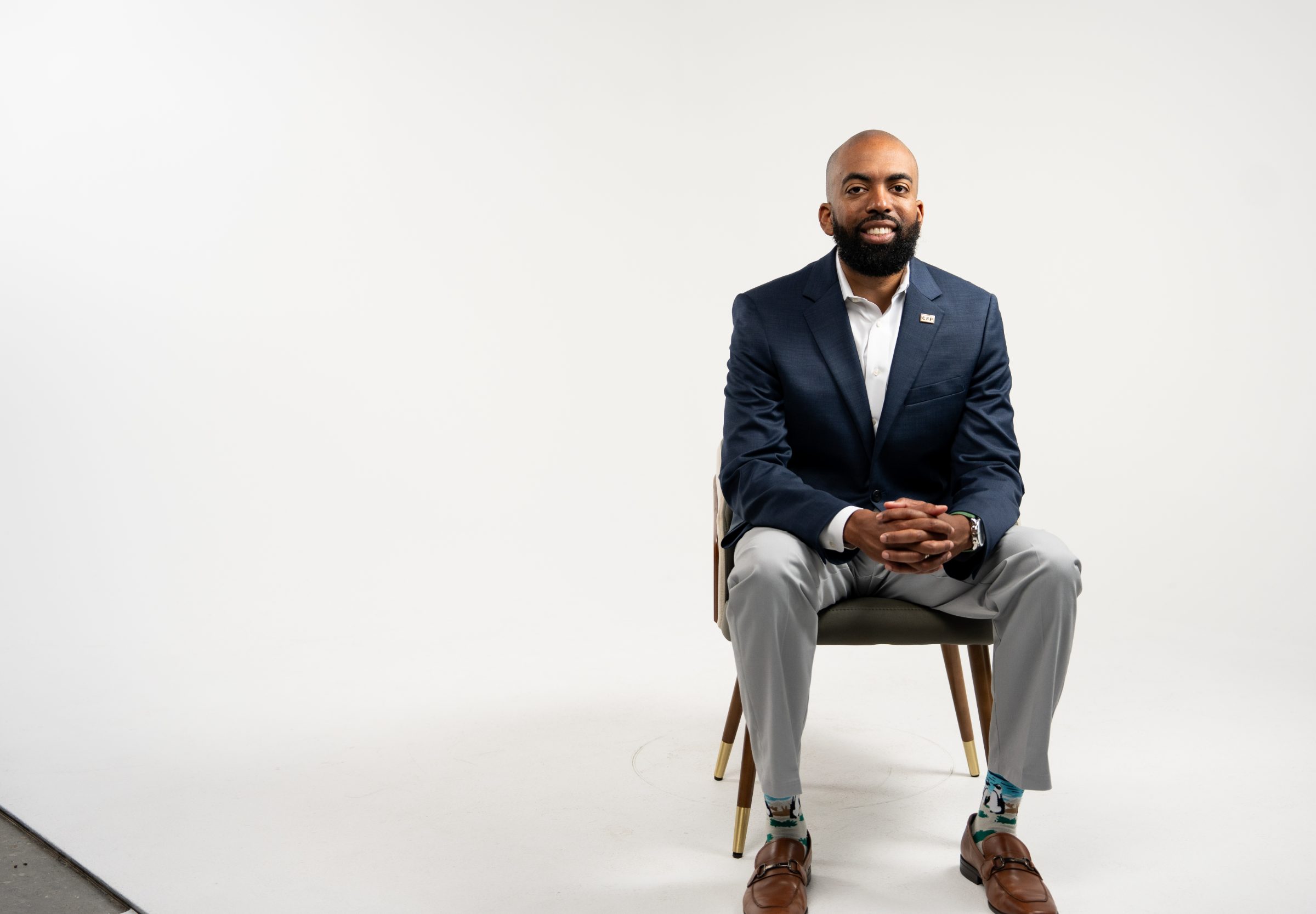 Markell Bryant, founder of Obedient Wealth Planning, seated in a studio portrait